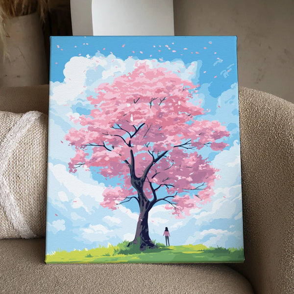 Woman standing under a blooming pink cherry blossom tree