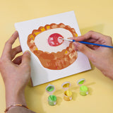 Sugar & Whimsy Paint by Numbers Kit by Artspark showing the painting process of a raspberry tart canvas with paint pots and brush.