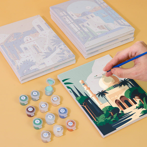 Painting process of Wanderlust Wonders paint by numbers set with acrylic paints and brushes.