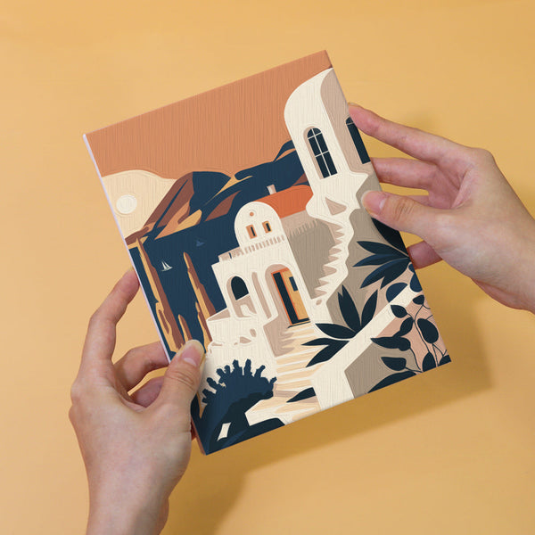 Hand holding completed painting from the Wanderlust Wonders set, featuring a Mediterranean-inspired architectural design.