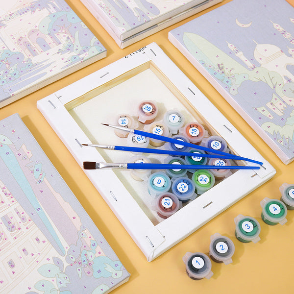 Linen canvas, paint containers, and brushes from the Wanderlust Wonders set, arranged for painting preparation.