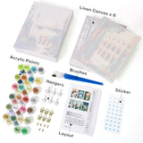 Wanderlust Wonders set with linen canvas, acrylic paints, brushes, hangers, stickers, and layout.