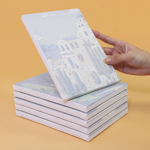 Stack of unpainted canvases from the Wanderlust Wonders set, ready for artistic creation.