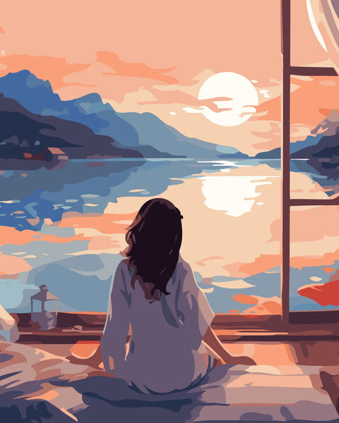 Woman sitting by window admiring peaceful lake at sunset